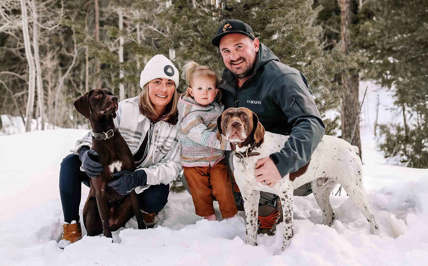 Family with dogs at outdoor winter photo session