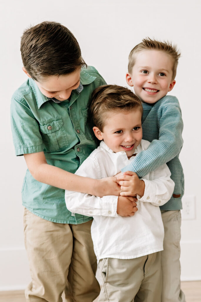 Siblings playing together at newborn photo session