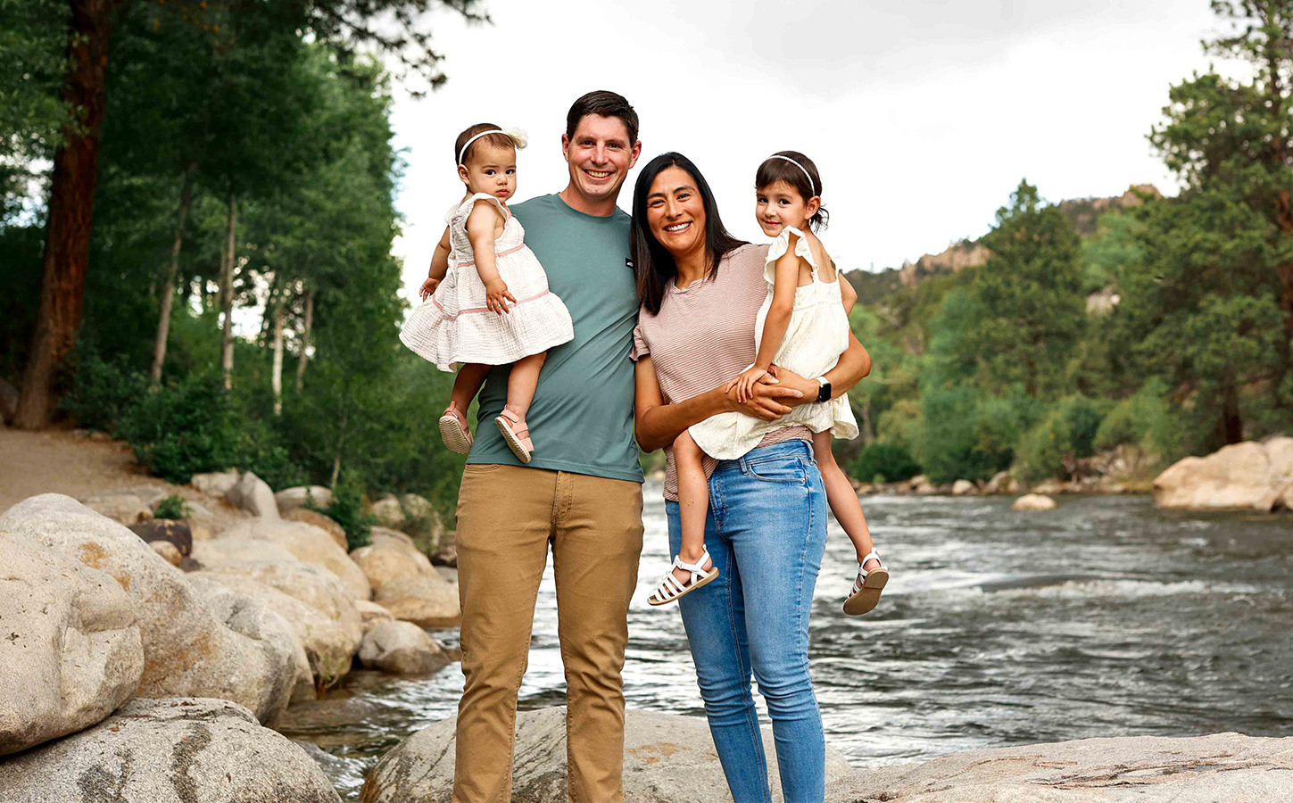 Family standing by river for photos in Buena Vista Colorado